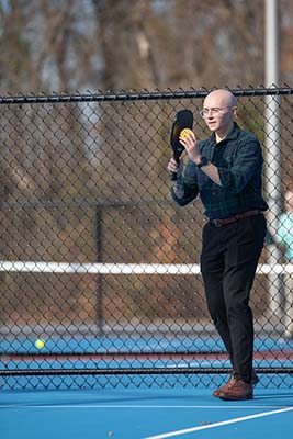 Guy playing pickleball